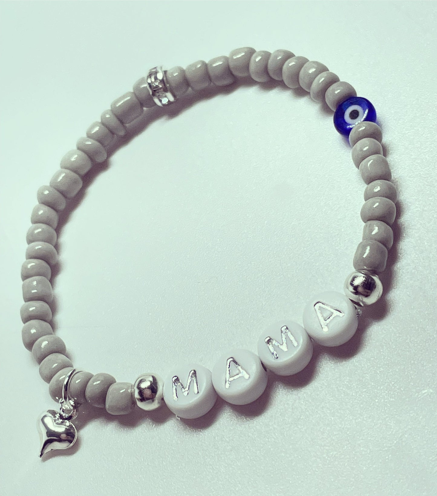 Personalised silk grey glass seed bead bracelet with evil eye